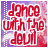 Red text reading "dance with the devil" on a purple background with white cloud shapes and dotted patterns, animated