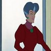 Animated character with blue hair styled in an updo, wearing a red dress with puffed sleeves and a green necklace, standing against a light background.