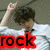 Pixelated image of a person with dark hair wearing white clothing, raising their right hand in a gesture above the word "rock" rendered in bold red and black text.