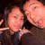 Two people pose closely together in a selfie-style image with one person making a playful face and the other smiling.