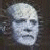 A 50x50 pixel buddy icon split into two frames showing a pale, bald character with closed eyes on the left and green text reading "Original Icons .com" on a dark background on the right.