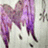 A static pixelated image of a figure with large purple wings, dark hair, and a light-colored top against a pale background.