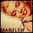Pixelated image of a person with reddish-brown hair, light skin tone, and visible eyes, mouth, nose; text at bottom reads 'MARILYN' in blocky letters.