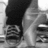 Pixelated grayscale image of a figure in dark pants and light shirt, partially cropped with visible background elements.