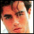 Pixelated close-up of a person's face with dark hair, visible eyes, nose, and mouth against a light background.