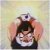 Pixelated image of a character with dark hair and a white collar, hands raised near head, against a soft gradient background.