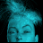 A woman's face with closed eyes and a blue-toned, pixelated appearance transitions from a static pose to an animated sequence of expanding particle effects.