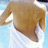 Pixelated image of a person's torso wearing a brown shirt with white sleeves against a light blue background.