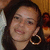 A person with long dark hair and large hoop earrings appears in a of four , with the bottom-right blank