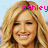 Pixelated close-up of a smiling person with long blonde hair, pink text reading 'ashley' overlaid at the top right, light blue background.