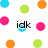 Pixelated image with scattered colored dots and partial text fragments on a white background.