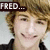 Pixelated close-up of a person with light brown hair wearing dark clothing, featuring a text overlay reading 'FRED...' in white letters on a black background.