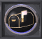 Animated circular icon with black background showing a golden mailbox and flag, the flag's glow shifts between light pink and bright white across frames.