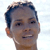 Static pixelated image of a person's head and upper neck with short dark hair, visible ear, and neutral expression against light background.
