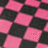 A static image of overlapping pink and dark green diamond shapes arranged in a repeating pattern.