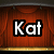 Red curtain background with gold trim displays text "Kat The Show Must Go On!" in white block letters with black outlines.