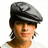 Pixelated image of a person wearing a gray flat cap and white shirt with pink text on a green background.