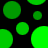 Green circular shapes of varying sizes on a black background, some partially obscured or split into segments.