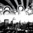Black-and-white pixelated image showing abstract shapes and partial text fragments against a white background.