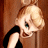A pixelated cartoon-style image of a blonde woman in a black dress on the left side, with green text reading "Original Icons .com" on a dark green background to the right.