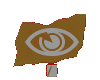 Brown flag-shaped icon with white eye symbol and internal spiral, mounted on a small rectangular base showing partial text.