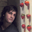 A pixelated image with a person on the left, strawberries on a wall behind them, and text reading "Let Me Take You Down to Strawberry Fields" in white block letters.
