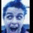 Pixelated blue-haired figure with wide eyes and open mouth, wearing dark clothing against light background.
