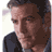 Pixelated static image of a person with brown hair and dark clothing against a light background, rendered in low-resolution 256x256 pixels.