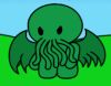 Green cartoon creature with large black eyes, wing-like appendages, and multiple tentacles in front of a blue sky and green ground.