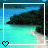 Pixelated beach scene with turquoise water, dark landmass, and white sand framed by a white border with a black heart icon.