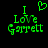 Green pixelated text on black background reads "I Love Garrett" with a heart symbol above the 'I' in the left view, and no heart in the right view.