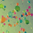 Pixelated abstract composition of scattered multicolored squares on a muted green background with no discernible subjects or text.