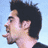 Two side-by-side pixelated frames of a man with dark hair in profile and three-quarter views against light backgrounds, one showing him looking left with mouth open, the other covering his mouth with a hand holding an orange object.