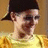 Pixelated image of a person in a yellow shirt with dark hair, set against an orange background with text elements.