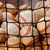 Pixelated grid of square tiles with brown, beige, and red tones showing partial abstract shapes.