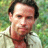 Static pixelated image of a person with short dark hair wearing a light-colored shirt against a green background.