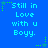 Blue background with repeated pixelated text "Still in Love with u Boyy." and green star-shaped decorations.