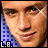 Pixelated static icon featuring a close-up of a person's face with blue grid pattern on left side and "L.B." text at bottom-left corner.
