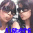 A pixelated image of two people with dark hair and bangs, wearing dark tops, with blue text and symbols overlaid.