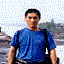 A person in a blue shirt and dark pants stands against a mountainous backdrop with water, transitioning through multiple poses including standing, walking, and turning.