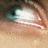 A four-quadrant image with a close-up of an eye in the top-left, teal text across other sections, and a solid gray block in bottom-right.