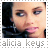 Alicia Keys face in two adjacent pixelated stamps with text below, one with light gray text, the other with black text.