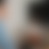 Pixelated gradient image with soft transitions between light gray, beige, blue, and brown tones, no distinct subjects or text visible.