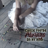 A person in a white dress sits on a wooden floor with hands clasped, surrounded by scattered colorful beads and text overlay.