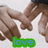 Two hands in a close-up pose with fingers interlocked, one hand wearing a white sleeve and the other brown sleeve, green text reading 'love' at bottom.