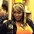 A pixelated image shows a person with long dark hair wearing a dark jacket over a light-colored shirt, holding a glowing yellow object against a bright yellow background.