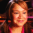 A pixelated image shows a person with brown hair and pink clothing on the left, next to text reading 'The REAL American Idol' in black letters over a light blue cloud shape.