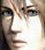 Pixelated close-up of a person's face showing eyes, nose, and mouth with light skin tones and dark hair strands visible.