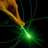 A pixelated image shows a green glowing object with orange and brown elements on the left against dark background.