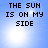 Four identical display pixelated text 'THE SUN IS ON MY SIDE' over a blue sky background with bright sun glares